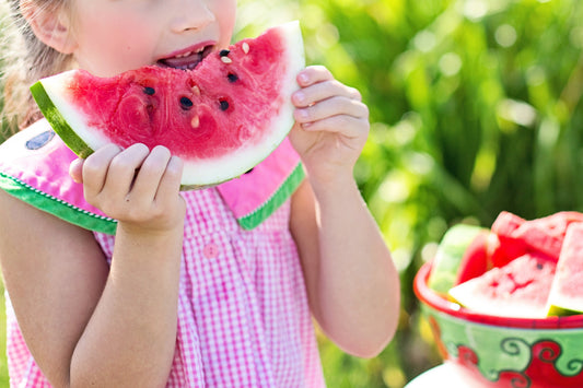 Girl eating watermelon - healthy food to help toddler gain weight | EnfaShop India